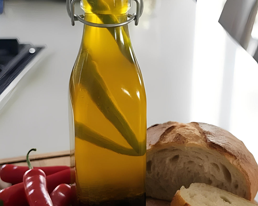 Chilli oil bottle with chili peppers and bread on kitchen counter, Cape Town, South Africa