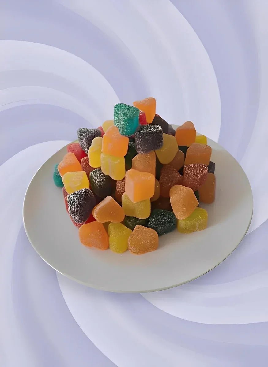 Colorful gummy candy on a white plate with a striped chair in the background