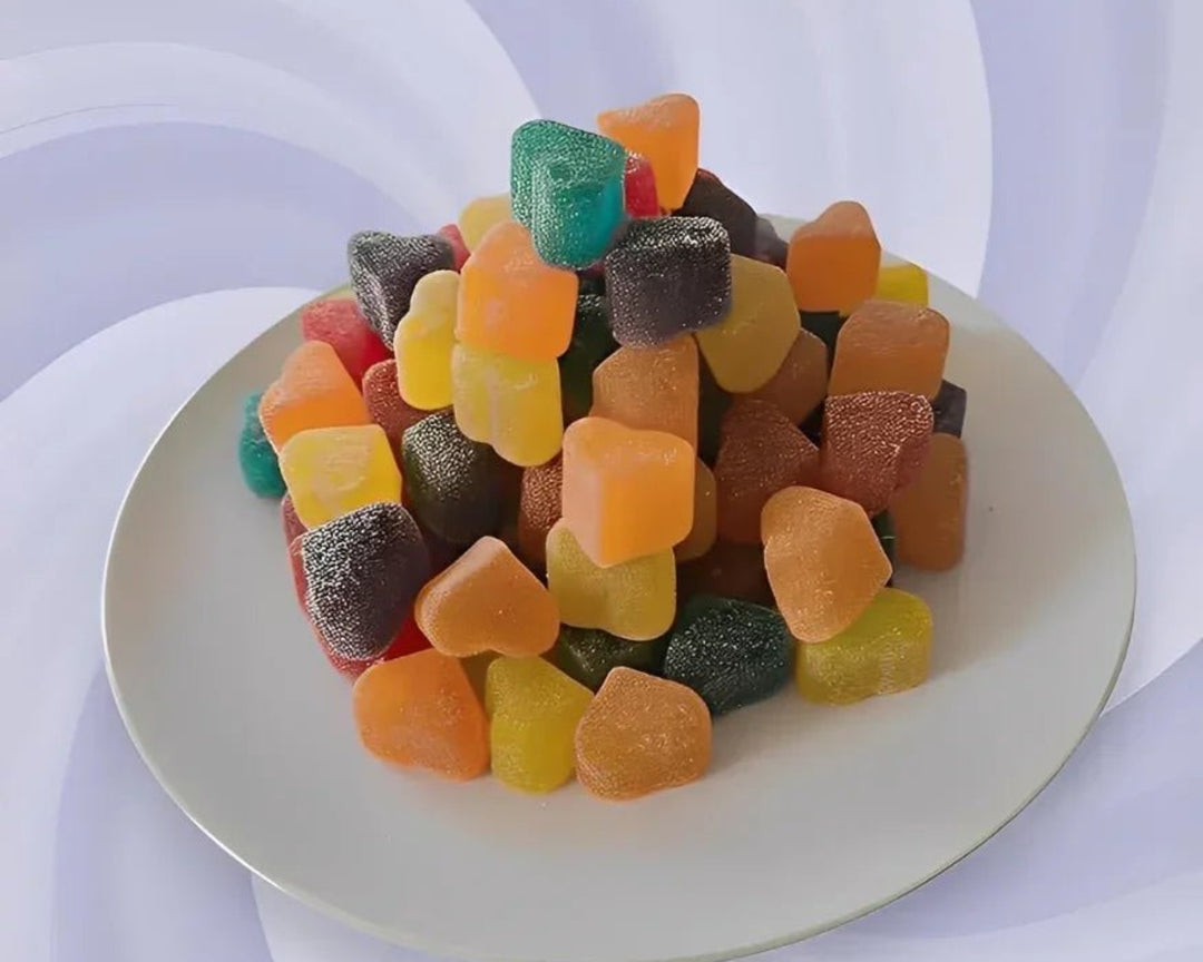Colorful gummy candy on a white plate with a striped chair in the background
