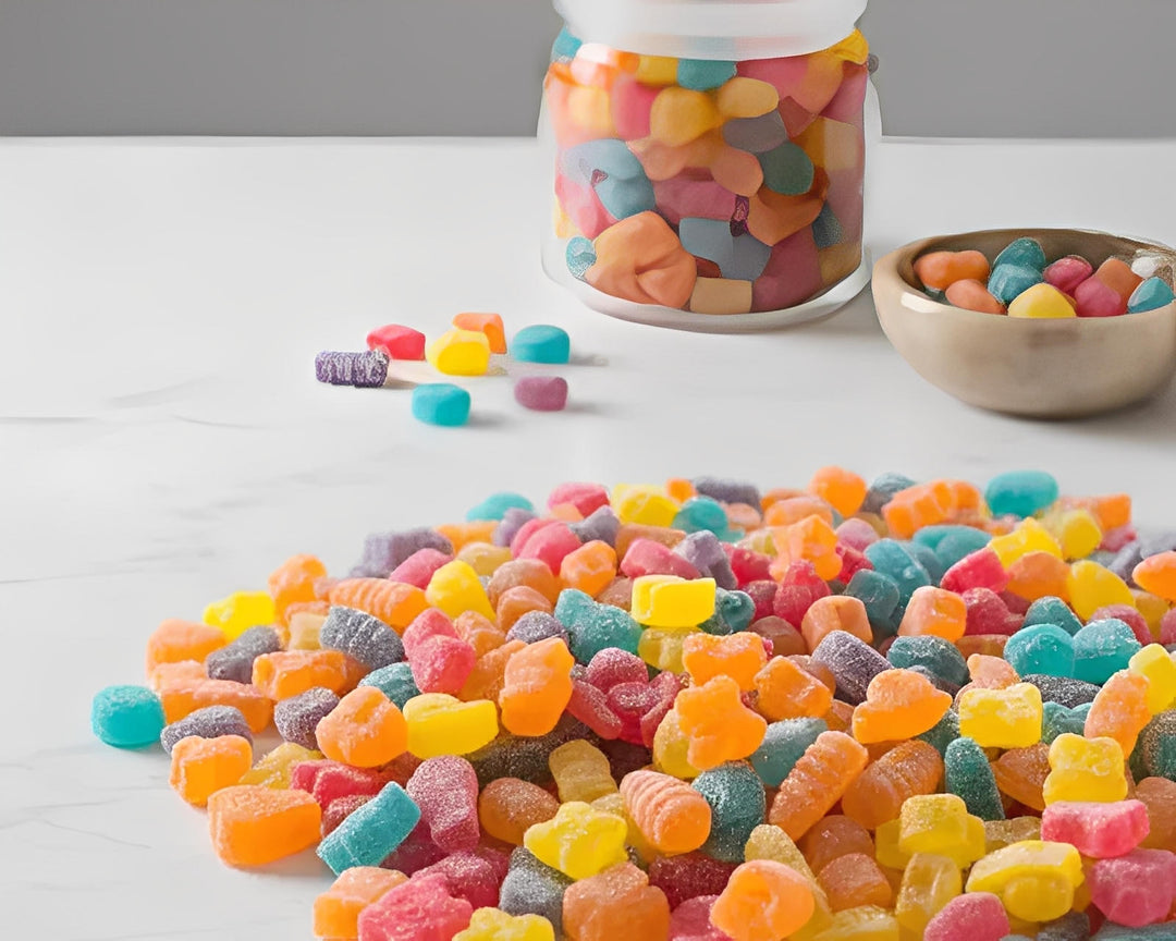 Assorted colorful cannabis gummies shaped like bugs on a marble surface in Cape Town