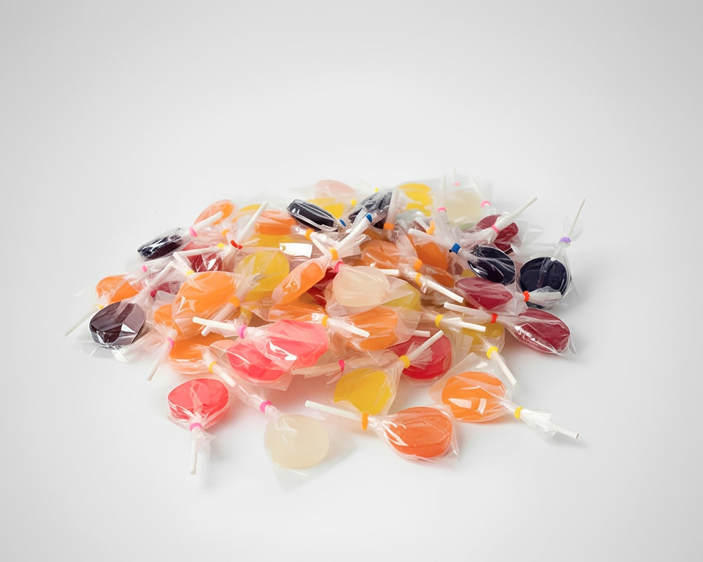 Assorted colorful lollipops on a light surface