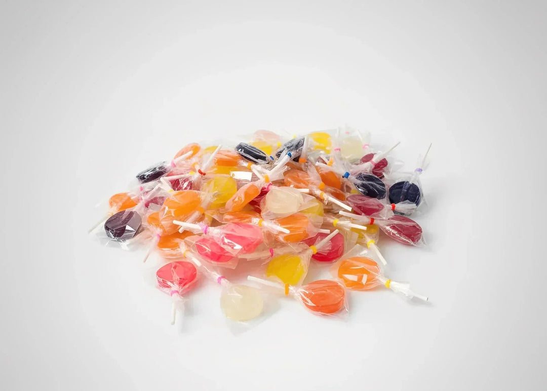 Assorted colorful lollipops on a light surface