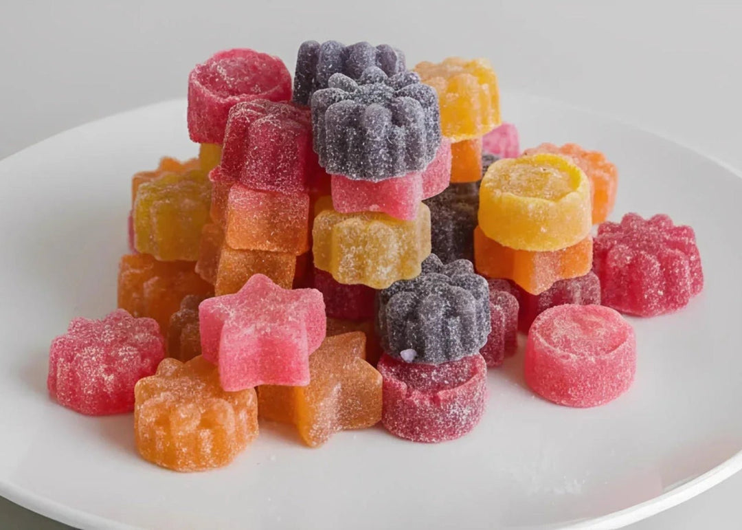 Assorted colorful gummy candies on a white plate