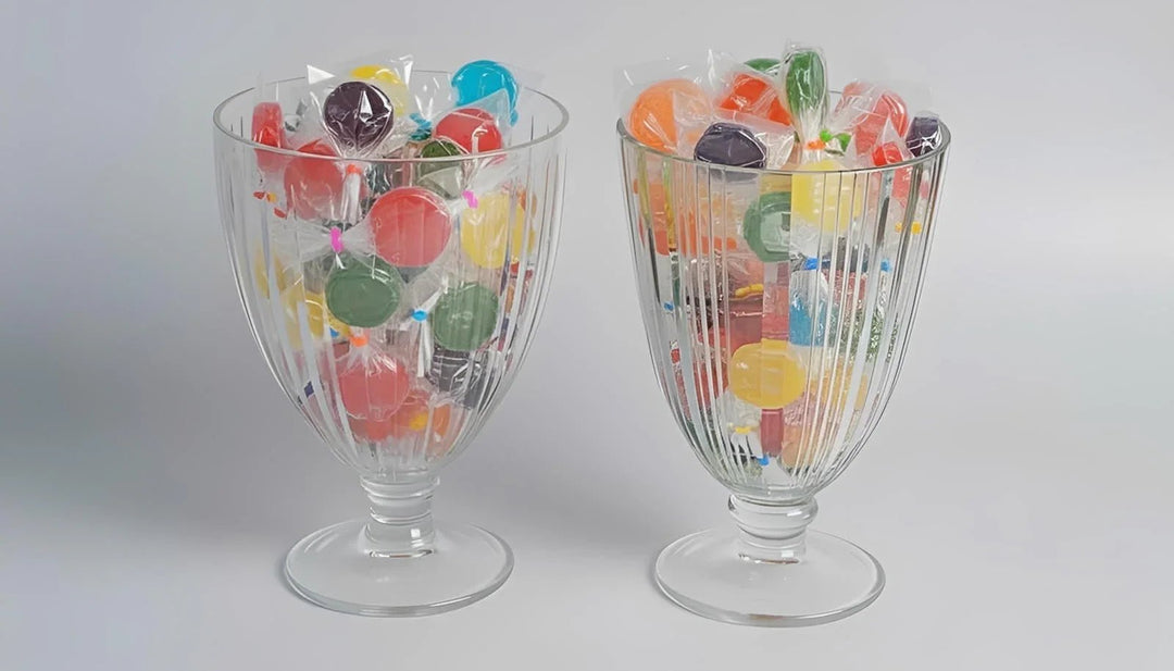 Clear containers filled with colorful gummy candies on a white background