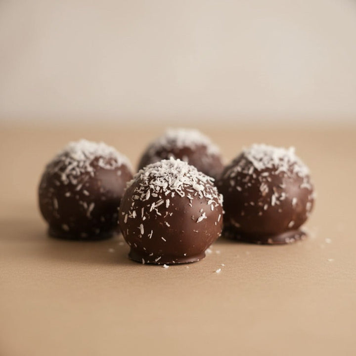 Chocolate truffles with coconut flakes on a wooden surface