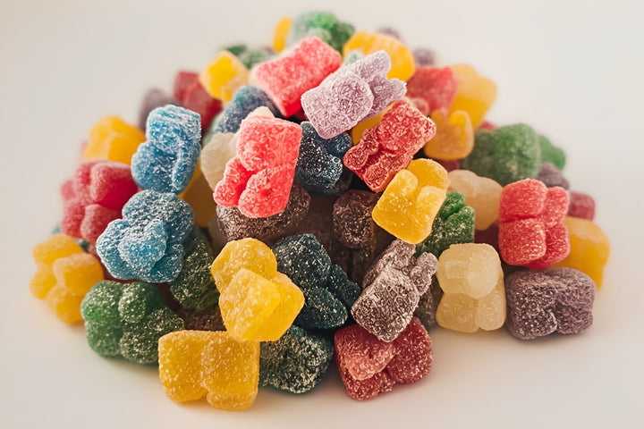 CBD gummy teddies stacked and displayed as colorful full-spectrum cannabis-infused edible treats